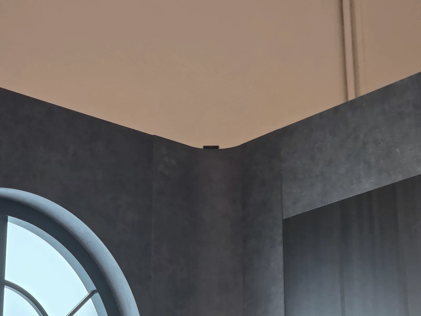 Slim camera mounted at the top of a booth wall
